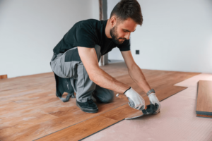 using-rubber-hammer-man-is-installing-new-laminated-wooden-floor_146671-89161 (1)